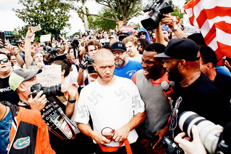 A man wearing a shirt with swastikas on it near the site of a planned speech by white nationalist Richard Spencer.